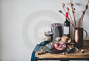 Red wine and different snacks on wooden board, copy space