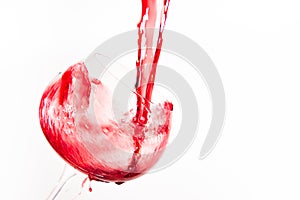 Red wine falling in a way splashing into a wine glass