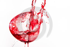 Red wine falling in a way splashing into a wine glass