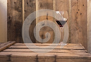 Red wine fine cristal glass on a wooden old table photo