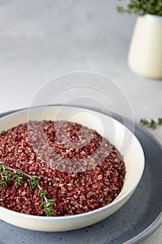 Red wine flavored salt in a bowl. Gourmet condiment to aromatize and season food