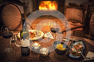Red wine and food in restaurant, winter time, romantic dinner