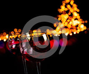 Red wine glass against bokeh lights background