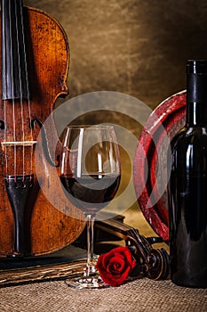 Red wine in glass, barell and violin