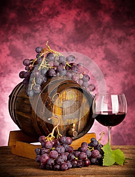 Red wine glass barrel with grapes