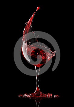 Red wine glass on black background