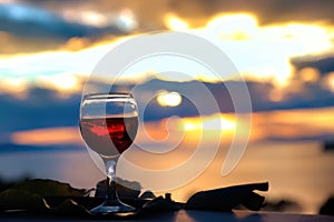 Red wine in a glass on the blurred background of the sky, clouds and sunset