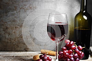 Red Wine Glass And Bottle On Wooden Table