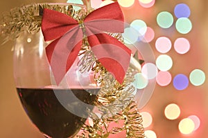 Red wine in glass with christmas tinsel