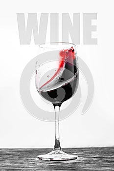 Red wine in the glass splashes in motion on a white background. Stylish design drink card with text