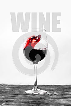 Red wine in the glass splashes in motion on a white background. Stylish design drink card with text