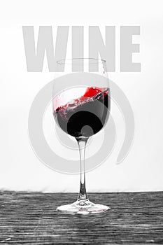 Red wine in the glass splashes in motion on a white background. Stylish design drink card with text