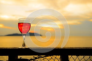 Red wine glass at sunset