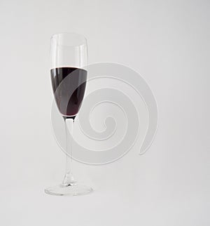 Red wine in a glass on white background