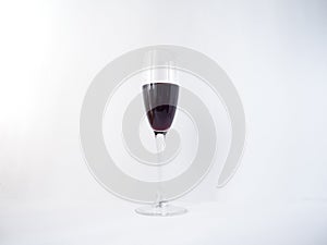 Red wine in a glass on white background