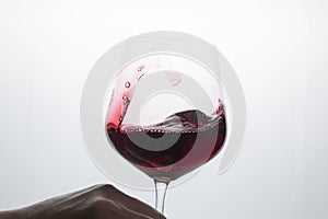 Red wine in a glass on a white background