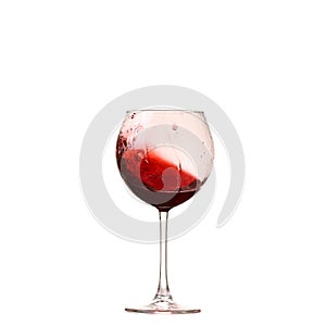 Red wine glass on a white background, splash