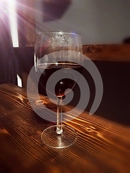 Red wine glass on wood table