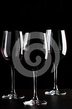 Red wine glasses on black background