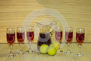Red wine in glasses and bottle natural grass mate background