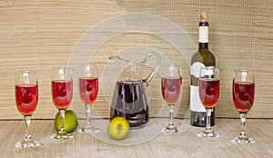 Red wine in glasses and bottle natural grass mate background