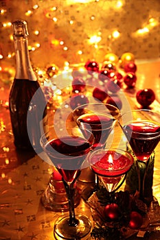 Red wine in glasses on golden background.