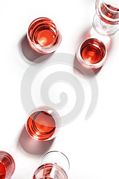 Red wine glasses on wine tasting. Degustation different varieties of red wine concept. White background, top view, hard light photo