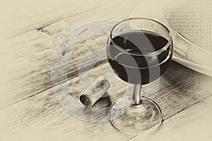 Red wine glasson wooden table. vintage filtered image. black and white style photo