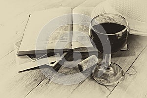 Red wine glasson wooden table. vintage filtered image. black and white style photo