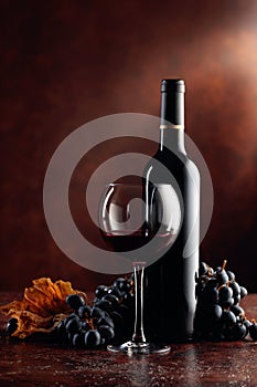 Red wine and grapes on a brown background