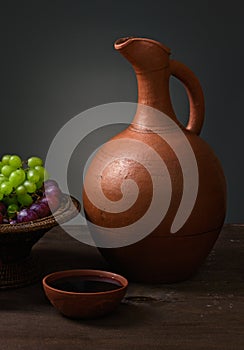 Red wine with grapes and a pitcher