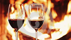 Red wine next to a fireplace, cozy and relaxing atmosphere at countryside home, romantic evening and holiday time background,