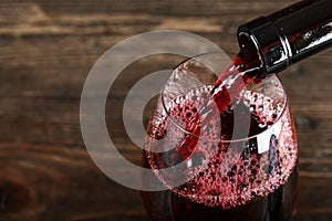 Red wine is poured from a bottle