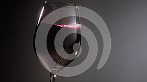 Red Wine Poured Into a Glass Against Neutral Background