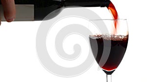 Red wine poured into glass isolated on white