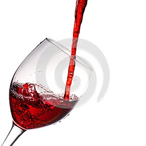Red wine poured into wine glass photo