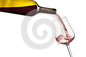 Red wine pouring from bottle into glass