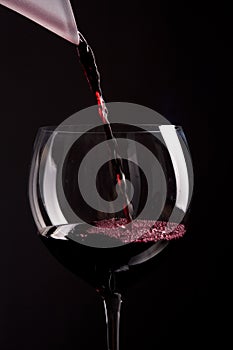 Red wine pouring in glass