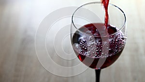 Red wine pouring into a glass