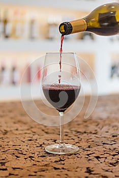 Red Wine pouring in a glass and Bottle