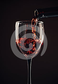 Red wine pouring glass