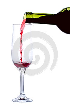 Red wine pouring into glass isolated