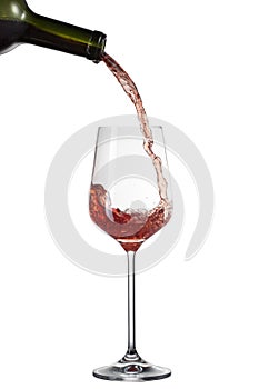 Red wine pouring into glass with splash isolated on white