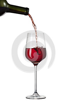 Red wine pouring into glass with splash isolated on white photo