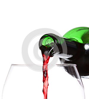 Red wine pouring on white background, closeup