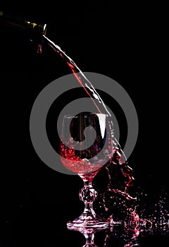 Red wine pouring into wine glass