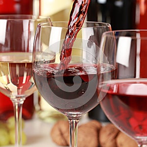 Red wine pouring into a wine glass photo