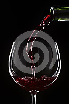 Red wine pouring into a wine glass