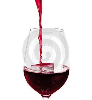 Red wine pouring into wine glass