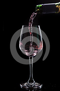 Red wine pouring into a wine glass